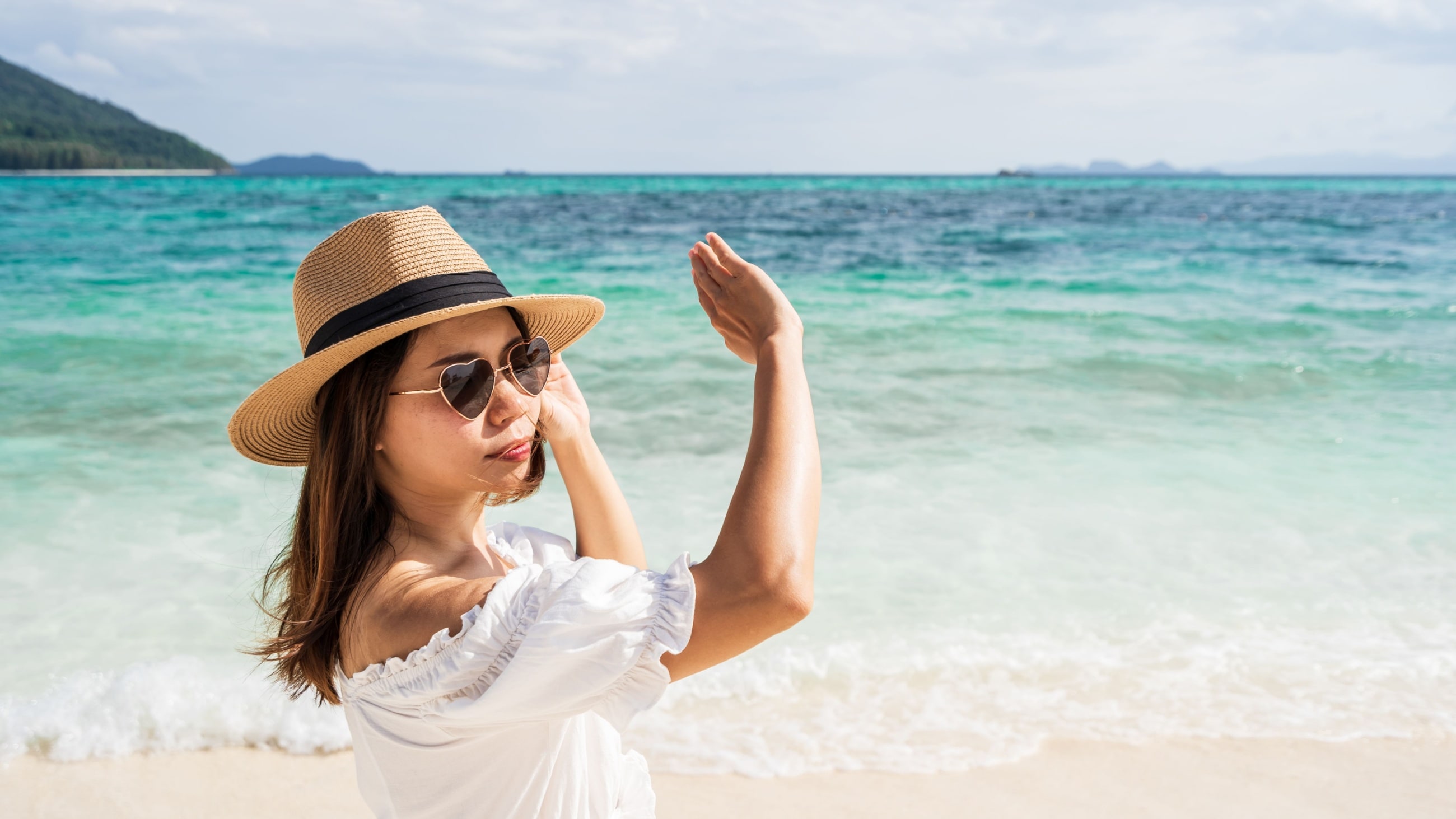 woman wearing uv protected sunglasses shielding her eyes from sun woman wearing uv protected sunglasses shielding her eyes from sun