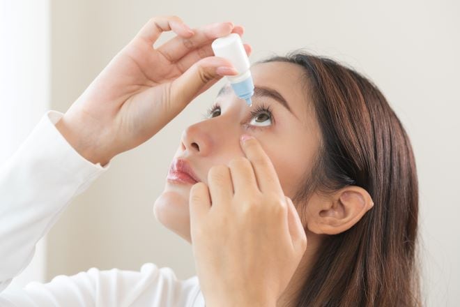 woman putting in eye drops