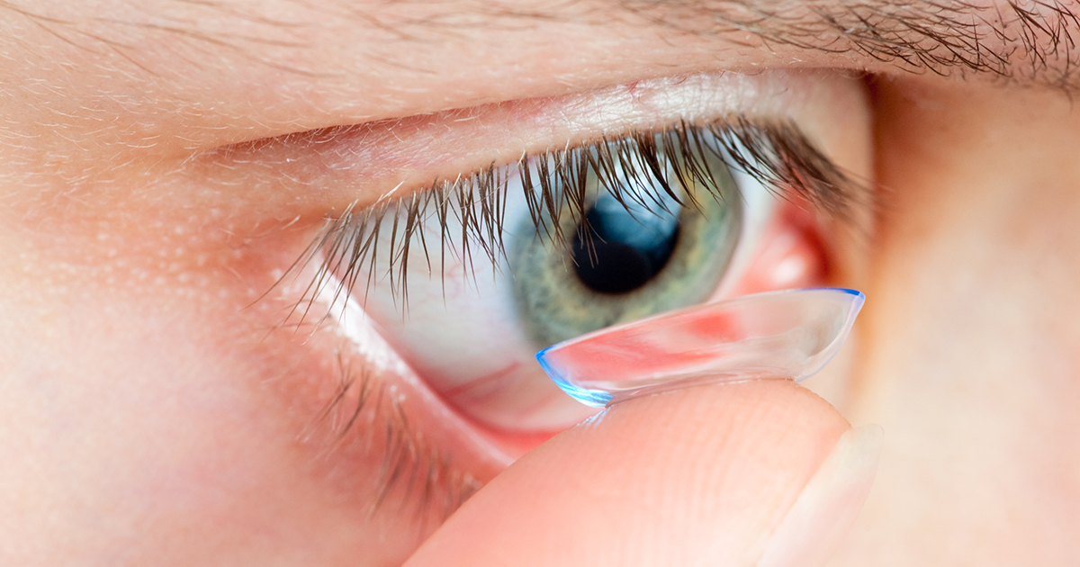 personne appliquant une lentille de contact