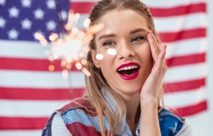 Young woman holding sparkler