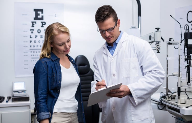 Patient with eye doctor. Patient with eye doctor.