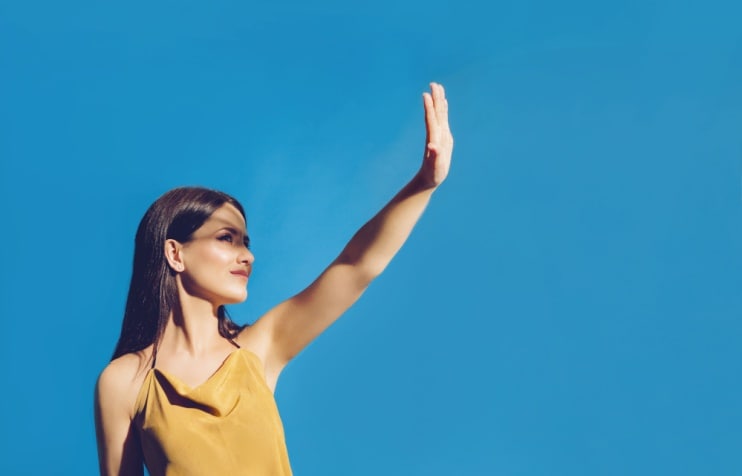 Woman shielding sun from her eyes.