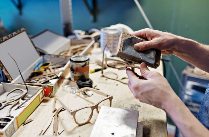 woman trying on different glasses frame shapes