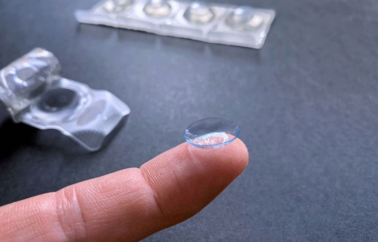 Contact lens resting on a fingertip