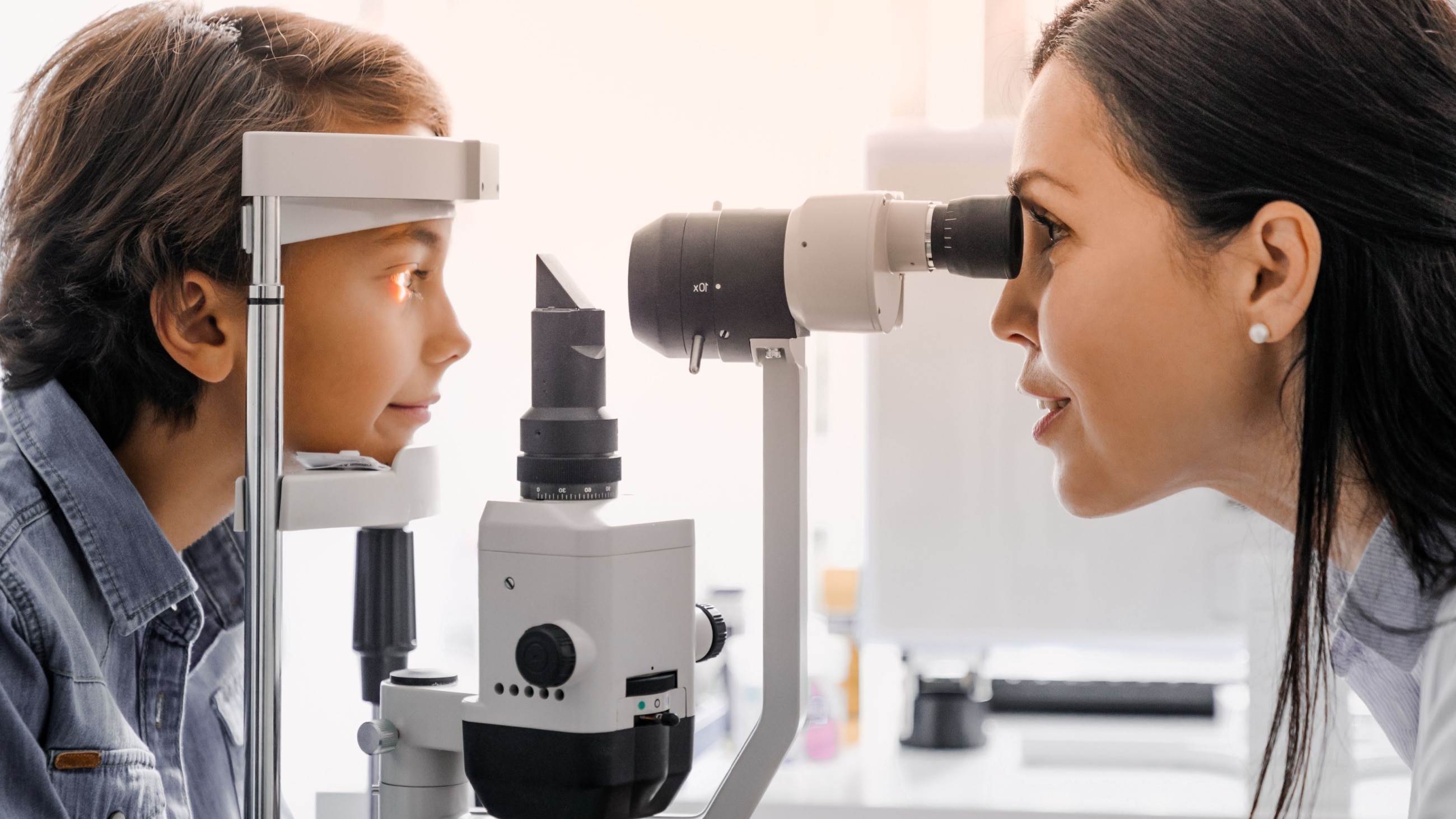 A little boy has his eyes examined by a pediatric optometrist.