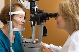 senior woman receiving eye exam