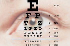 woman holding up a Snellen eye chart