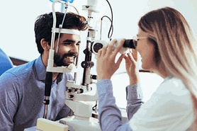 man having his eyes examined