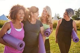 group of older woman with yoga mats