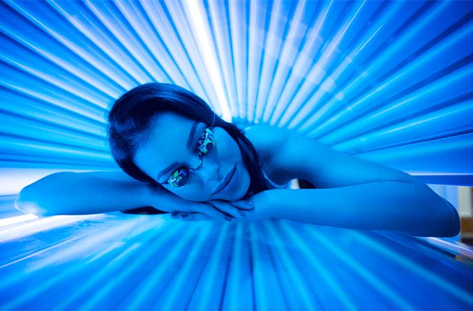 woman in tanning bed with uv light woman in tanning bed with uv light