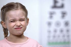child squinting at eye chart