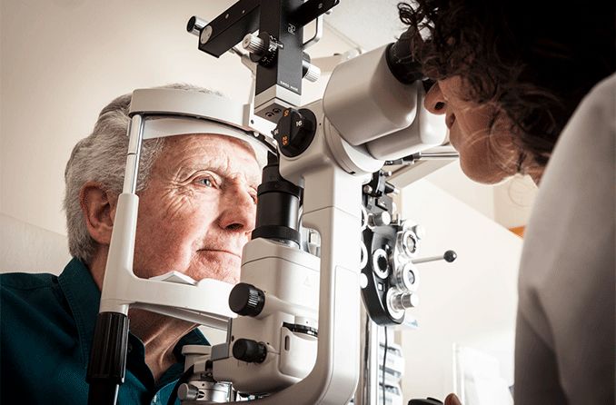 elderly man getting eye exam checking for retinoschisis elderly man getting eye exam checking for retinoschisis