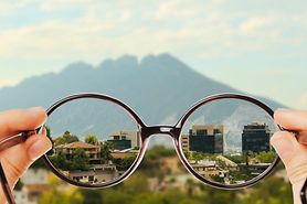 Looking through glasses at a mountain landscape, showing the difference between myopia and corrected vision through the lenses. Looking through glasses at a mountain landscape, showing the difference between myopia and corrected vision through the lenses.