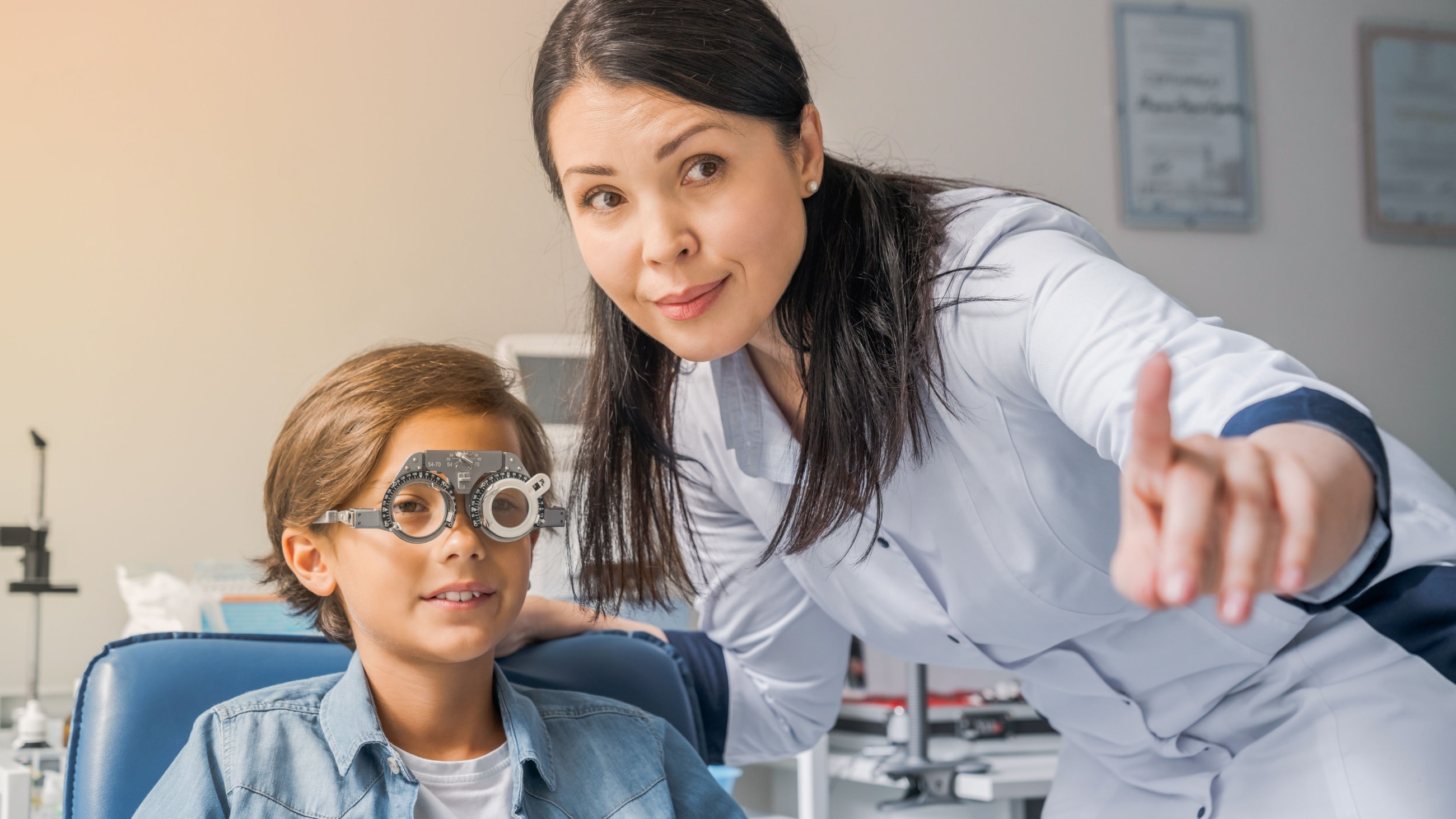 A young boy wearing glasses gets help with his homework