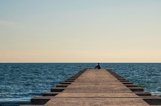 person at the end of the dock staring out into the distance hoping for a nearsighted cure
