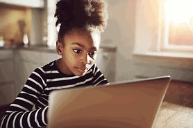 girl staring at computer screen