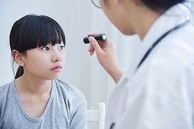 young girl getting eye exam to get checked for pediatric cataracts