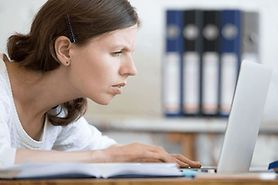 woman with eye strain and improper posture at computer