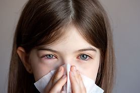 Girl with pink eyes and a cold