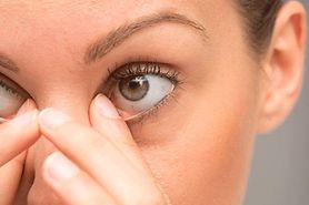 woman wiping away her eye boogers