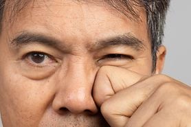 Woman rubbing her eyes to deal with eyelid twitching