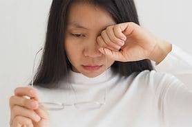 woman irritated by her eye floaters