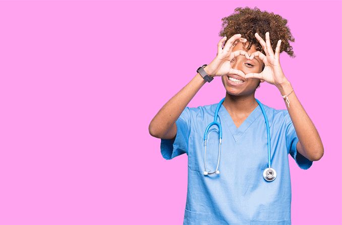 doctor holding up fingers to her eye in the shape of a heart doctor holding up fingers to her eye in the shape of a heart