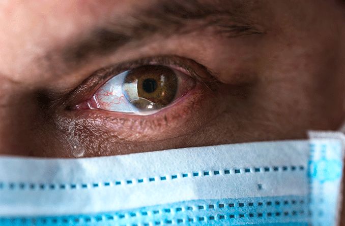man wearing a face mask that causes dry eyes man wearing a face mask that causes dry eyes