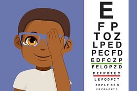 Child covering his eye at an eye exam.