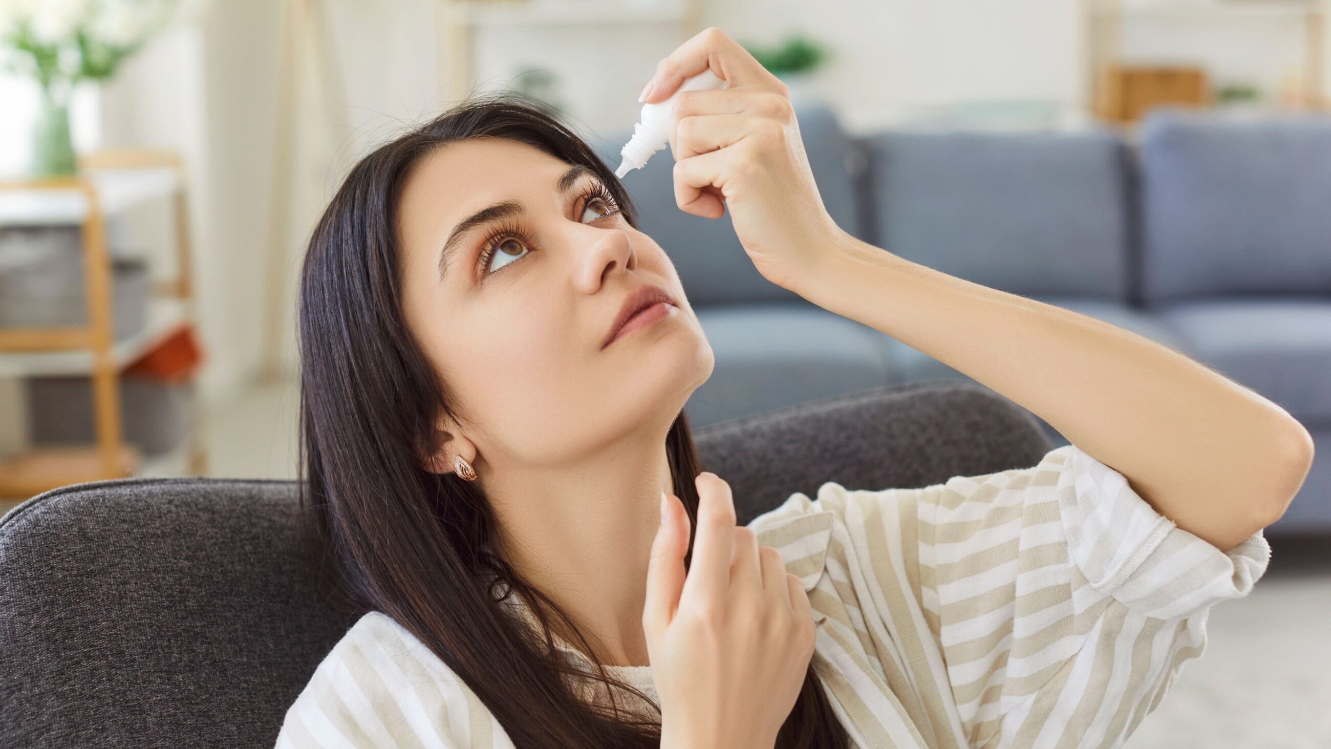 woman putting in eye drops