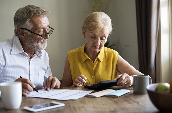 senior couple looking over vision insurance paperwork