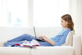 girl on couch using laptop computer girl on couch using laptop computer
