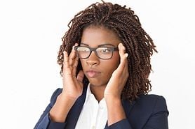 woman adjusting her eyeglasses at home