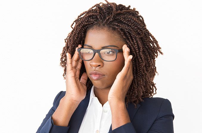 woman adjusting her eyeglasses at home