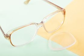 pair of eyeglasses with one lens popped out