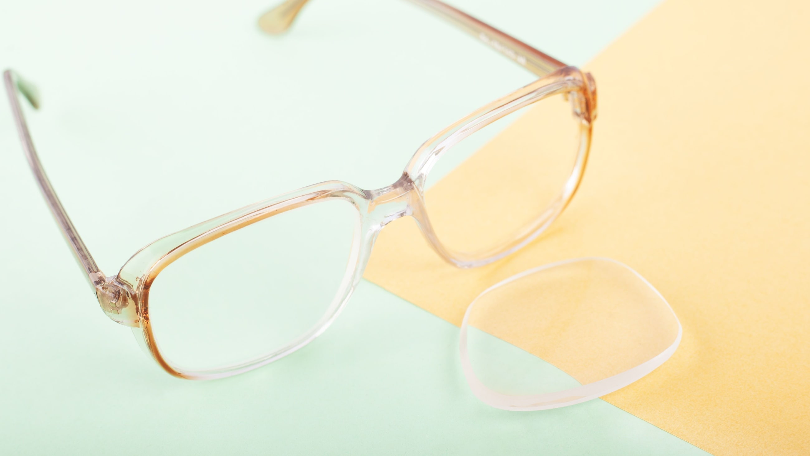 pair of eyeglasses with one lens popped out
