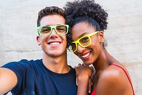 posing couple both wearing non-prescription glasses
