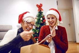 mother and daughter opening Christmas presents