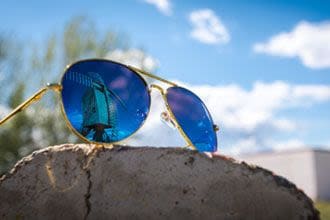 Blue-tinted Aviator sunglasses.