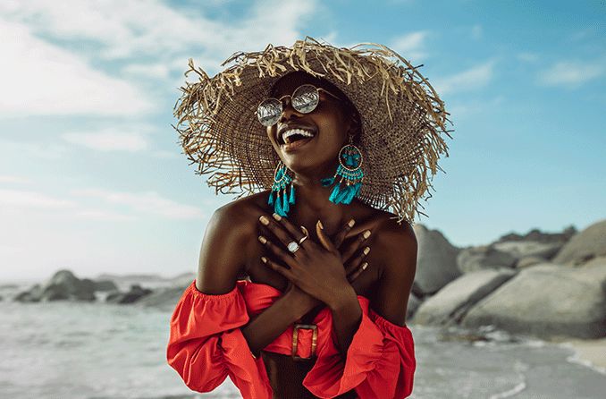 woman on the beach wearing a sunglasses and a hat woman on the beach wearing a sunglasses and a hat