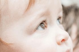 Close-up of child's eyes looking upward. 